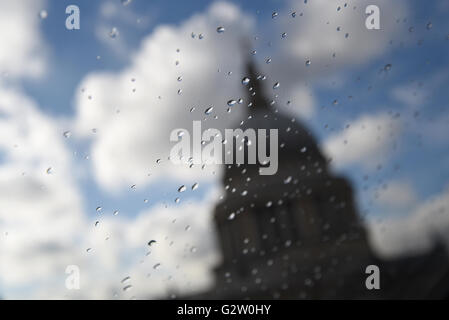 Looking through raindrops on a pane of glass to an unfocused St Paul's Cathedral, London. Stock Photo
