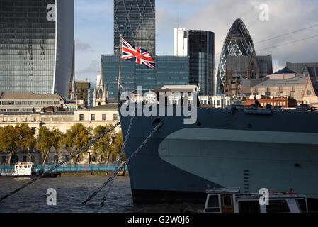Britain's Union Jack flies proudly in the wind on the front of HMS Belfast, London. Stock Photo