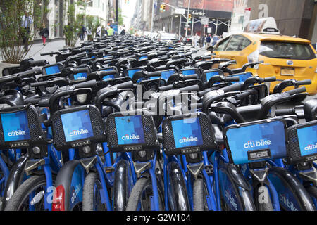 Renting bicycles around Manhattan has gotten very popular inspite of the heavy auto traffic. Citi Bike storage station. Stock Photo