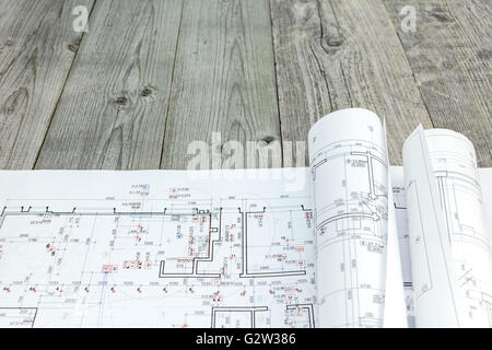 floor plan drawings with rolled architectural blueprints on wooden background Stock Photo