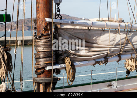 The hawser on the sailboat mast and the square sail Stock Photo