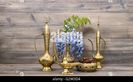 Arabic jug, vase, lamp, tea pot. Fruits and flowers. Golden oriental decorations. Food and drink Stock Photo