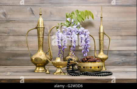 Vintage arabic jug, vase, lamp, tea pot, islamic rosary beads. Fruits and flowers. Oriental holidays decoration. Ramadan kareem Stock Photo
