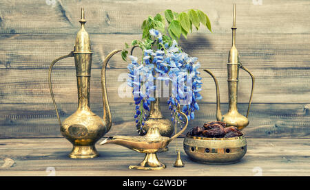 Antique arabic jug, vase, lamp, tea pot. Fruits and flowers. Golden oriental decorations. Vintage style toned picture Stock Photo