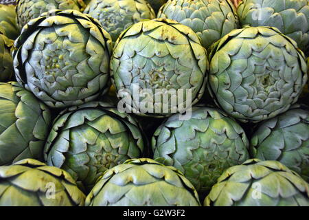 DIsplay of globe artichokes on a market stall Stock Photo