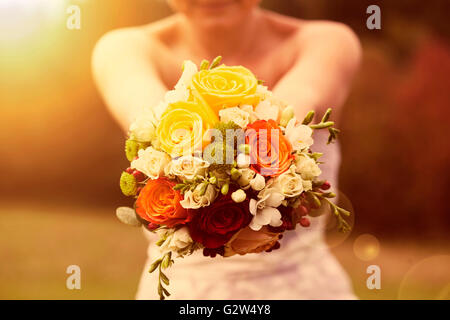 Beautiful wedding bouquet in hands of the bride Stock Photo