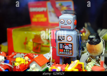 A vintage toy robot, amongst other old toys Stock Photo