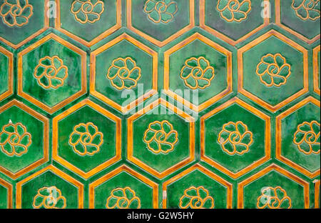 Green glazed tiles with a lotus bloom background in the center of each at the Forbidden city Beijing China. Stock Photo