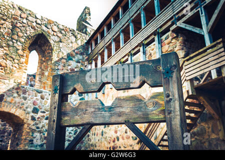 Wooden medieval torture device, ancient pillory in old castle. Stock Photo