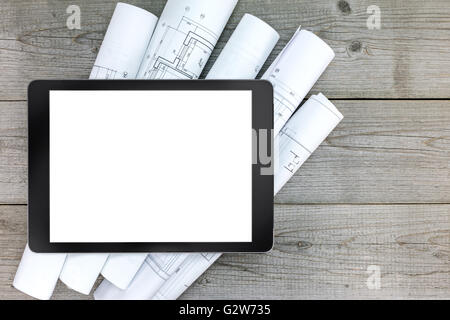 architectural blueprints with blank tablet on gray wooden boards Stock Photo