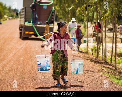 Sot Nikum, Siem Reap, Cambodia. 3rd June, 2016. A man carries water to ...