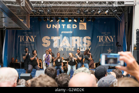 The cast of The Colour Purple Broadway production performing one of their songs at the free Stars in the Alley concert in Shubert Alley, New York. Stock Photo