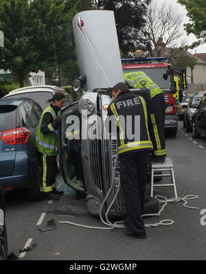 Kew, Richmond, UK. 3rd June, 2016. Emergency services attend a Mini involved in a single-car crash on Burlington Avenue a residential road here 3rd June 2016. HUGH ALEXANDER/Alamy Live News Stock Photo