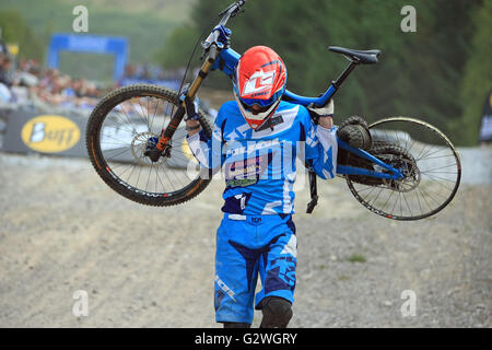 Fort William, Scotland, UK, 04th June, 2016. Ben Cathro carrying his bike across the line during his qualifying run for the Downhill Mountain Bike World Cup at Fort William, Scotland on June 4th 2016. Credit:  Malcolm Gallon/Alamy Live News Stock Photo