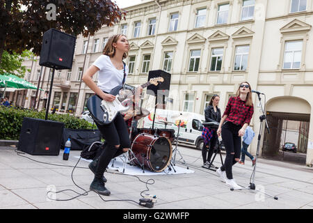 Teenage girl rock band performing on the street Stock Photo