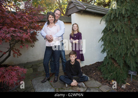 A Caucasian family of four pose for photographs at JC Arboretum in Raleigh, NC, USA.