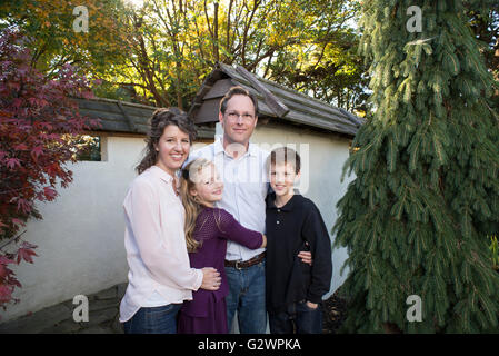 A Caucasian family of four pose for photographs at JC Arboretum in Raleigh, NC, USA.