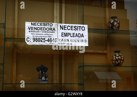 Notice advertising work for sales assistant and domestic help in Spanish on shop window, Miraflores, Lima, Peru Stock Photo