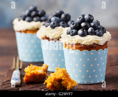 Pumpkin cupcakes with cream cheese, blueberries Stock Photo