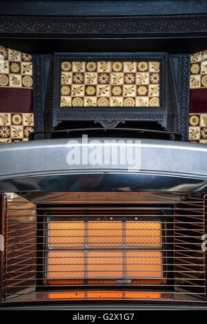 Gas fire in front of vintage Fireplace Stock Photo