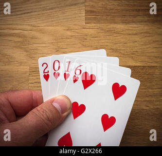 Playing card 2016 with heart on wood background Stock Photo