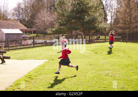 Female Elementary School Pupils Playing Tag At Breaktime Stock Photo