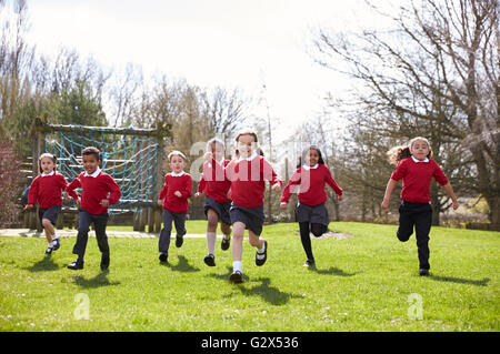 Elementary School Pupils Running In Playground At Breaktime Stock Photo