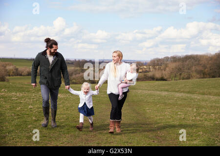 Family Holding Hands On Winter Country Walk Stock Photo