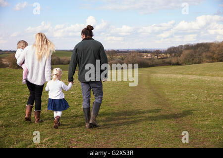 Rear View Of Family On Winter Country Walk Stock Photo