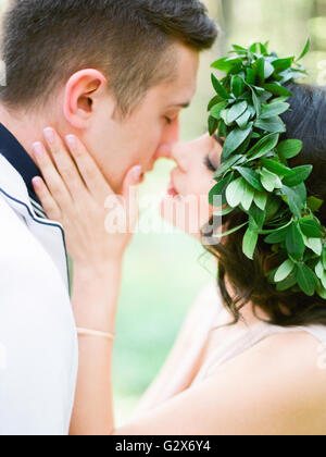 Two golden wedding rings in heart-shaped box with cute scroll stylized as musical notes isolated at rustic wooden furniture background Stock Photo