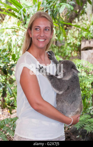 Young woman holding Koala at Lone Pine Koala Sanctuary, Fig Tree Pocket, Brisbane, Queensland, Australia Stock Photo