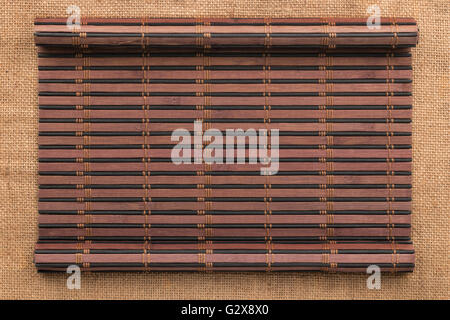 Bamboo mat in the form of a manuscript on sackcloth, top view Stock Photo