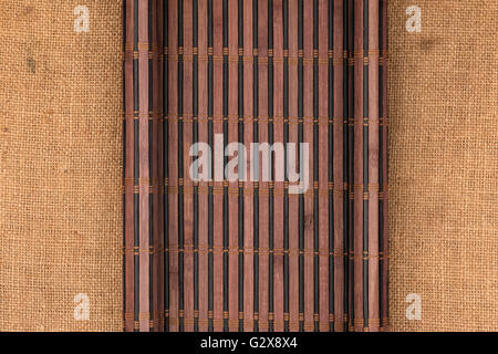 Bamboo mat in the form of a manuscript on sackcloth, top view Stock Photo