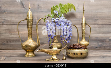 Vintage arabic jug, vase, lamp, tea pot. Fruits and flowers. Golden oriental decorations Stock Photo