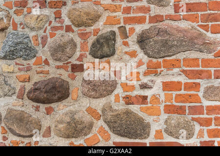 Details of a wall made of bricks and rubble stones Stock Photo