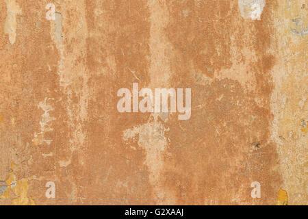 Details of a old concrete wall with cracks in orange color Stock Photo