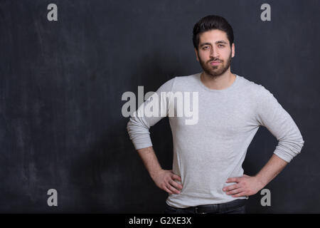 Confident and well-dressed. Handsome young man in smart casual wear looking at camera while standing against grey background Stock Photo