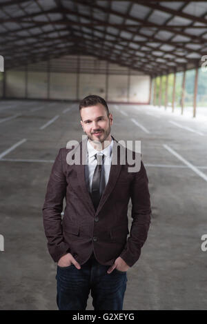 Young fashionable men in fron tof empty space for renting Stock Photo