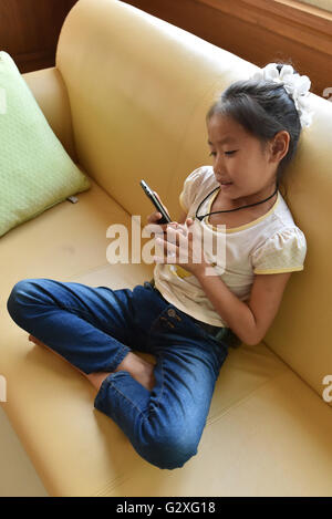 Laos, girl with mobile phone Stock Photo
