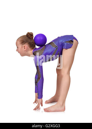 young girl in blue clothes doing gymnastics with red ball,  isolated on white Stock Photo