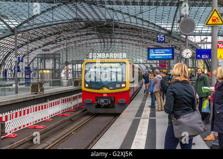 Passengers waiting on the platform for an approaching S- Bahn train at Berlin's Hauptbanhof station, the main central rail station in Berlin, Germany Stock Photo