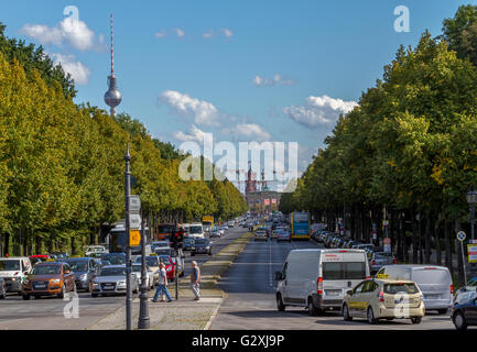 Looking down the B5 road in the Tiergarten towards The Brandenburg Gate with the TV Tower  appearing over the trees in the distance ,Berlin, Germany Stock Photo