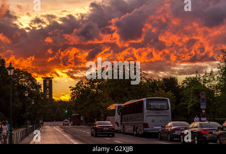 Fiery sunset skies over Berlin near ,with the Carillon Bell Tower in the distance  in the distance , Berlin Germany Stock Photo