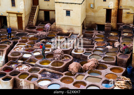 Fez, Morocco - April 11, 2016: Tree man working in a tannery in the city of Fez in Morocco. Stock Photo