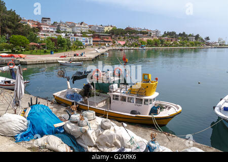 SINOP, TURKEY - MAY 14, 2016 : View of small fishing boats on coastline of Gerze Port in Sinop, on blue sky background. Stock Photo