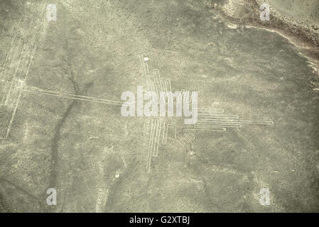 Aerial view of geoglyphs near Nazca - famous Nazca Lines, Peru. In the center, Hummingbird figure is present Stock Photo