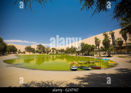 Oasis surrounded by sand dunes near Ica Peru Stock Photo