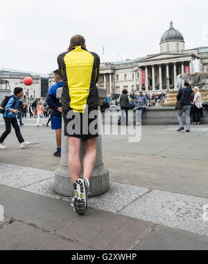 A male jogger in Trafalgar Square in London's West End, England, UK Stock Photo