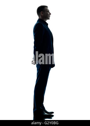 one caucasian business man standing profile silhouette isolated on white background Stock Photo