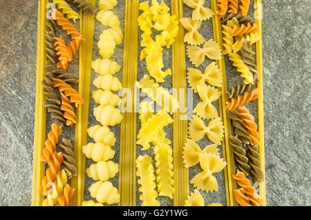 Pasta mix arranged on a stone table Stock Photo